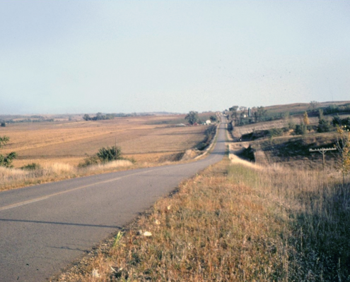A road running through Northwest Iowa plains
