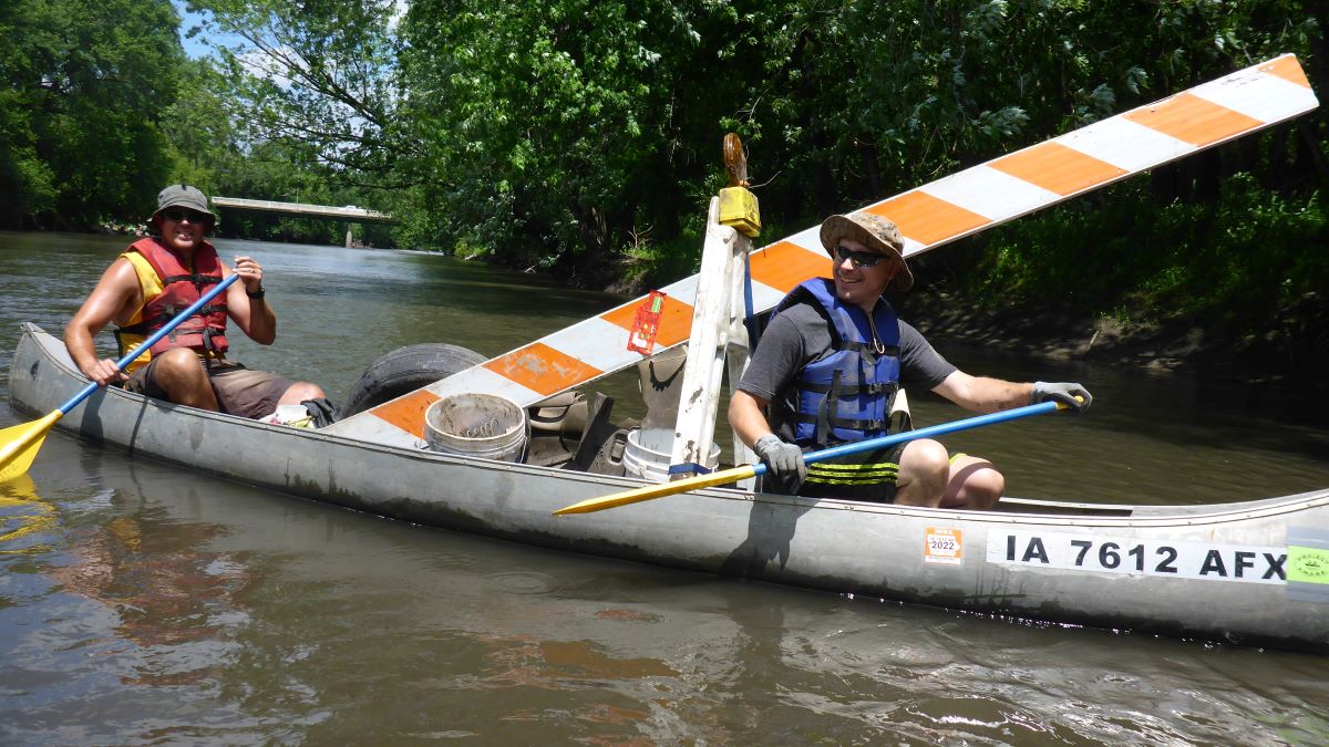 Ryan Clark and fellow volunteer Jeremy Davis with a full boat of trash