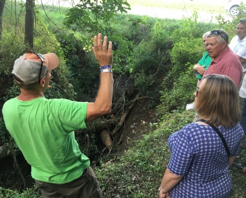 People standing around a sinkhole