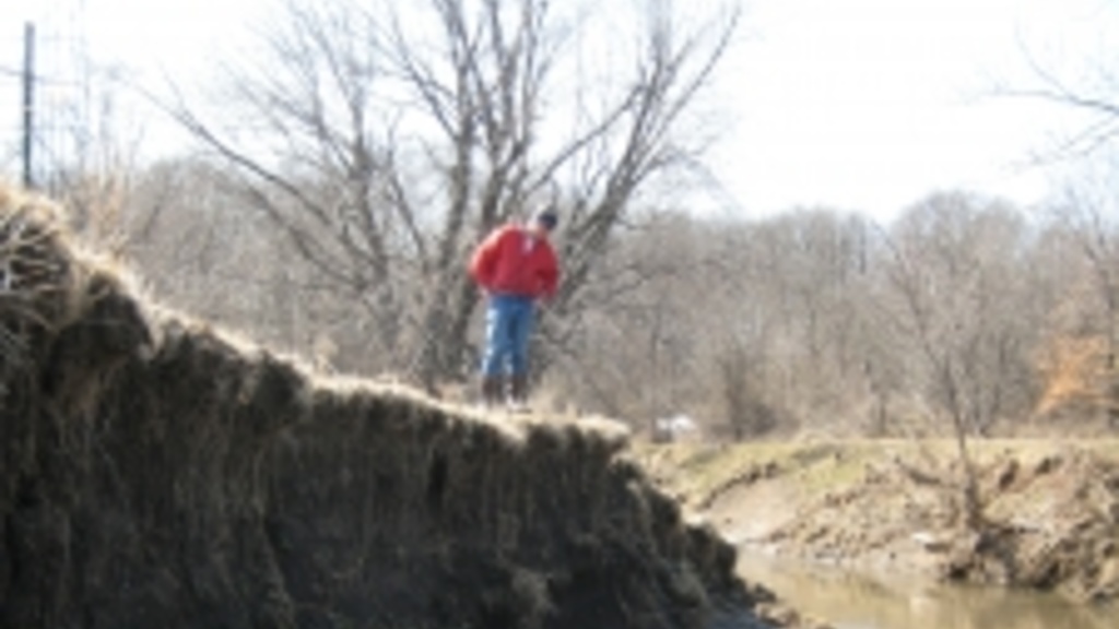 A person walking on a streambank